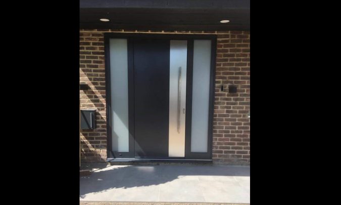 Front door with applique under the handle