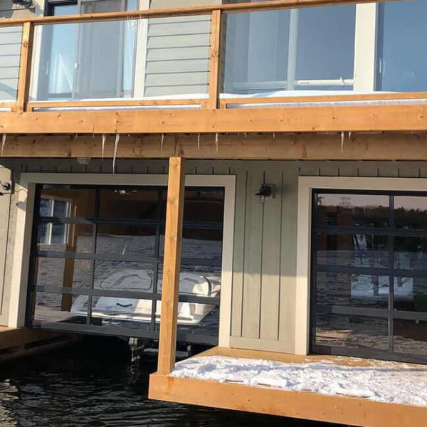 Glazed sectional garage door for boat garage