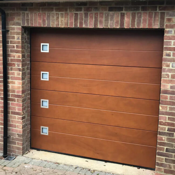 Sectional garage door - okoume clad with windows