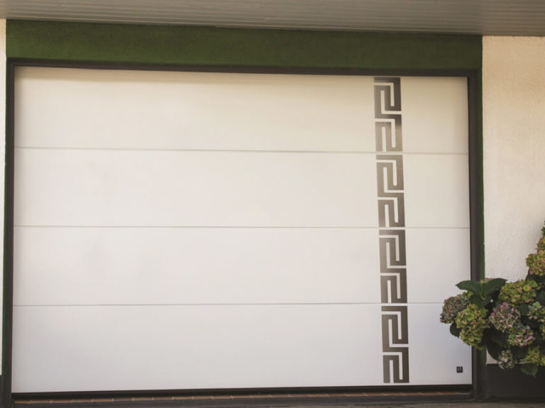 Garage door with stainless metal decor