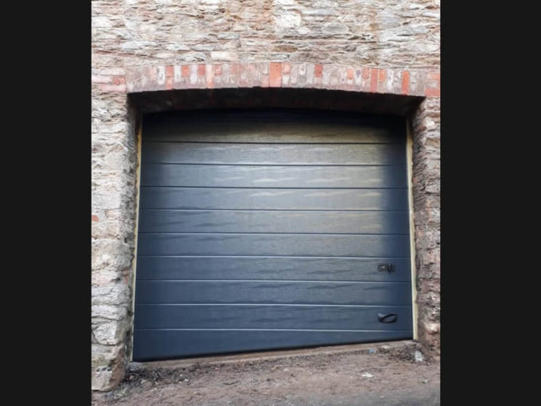 Garage door on a side-sloping driveway