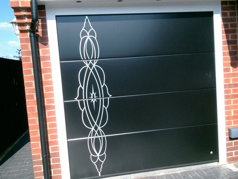 Garage door with custom design stainless metal applique