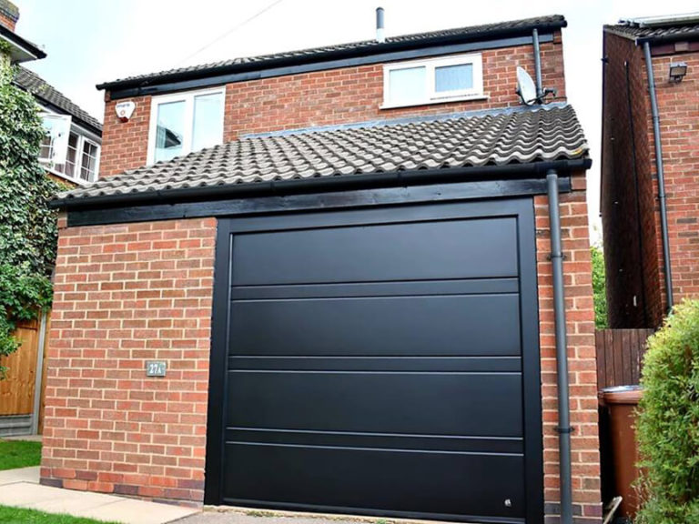 Red bricks house & black 'Toprib' garage door