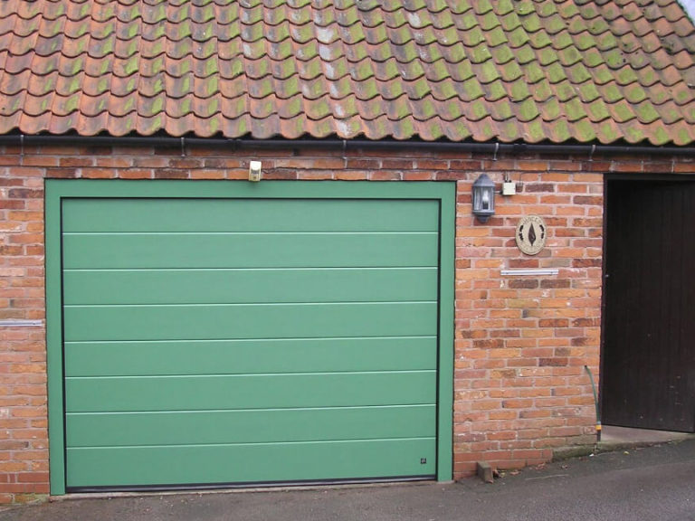 Red brick house & green garage door