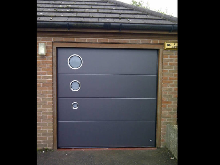 Garage door with 3-size portholes