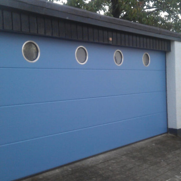 Sectional garage door with portholes