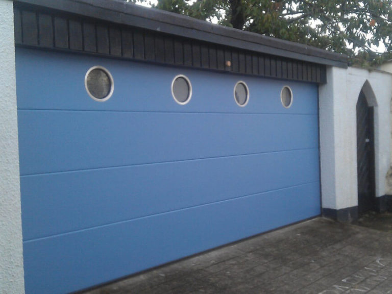 Sectional garage door with portholes