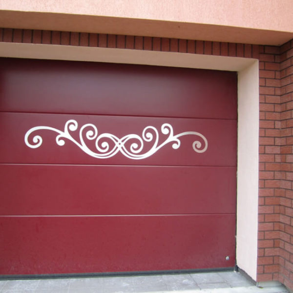 Sectional garage door with custom stainless metal motif