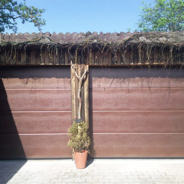 Sectional garage doors with 'Old copper' panels