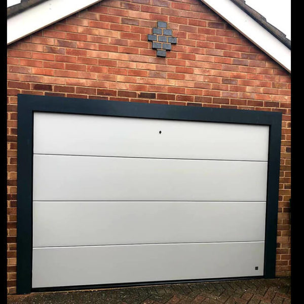 White garage door with black aluminium frame