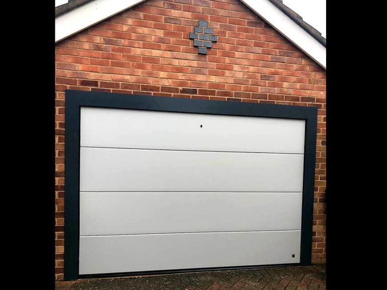 White garage door with black aluminium frame