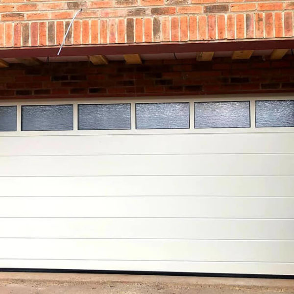 Garage door with glazed panel