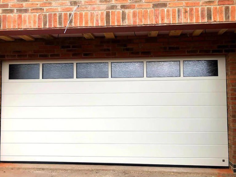 Garage door with glazed panel
