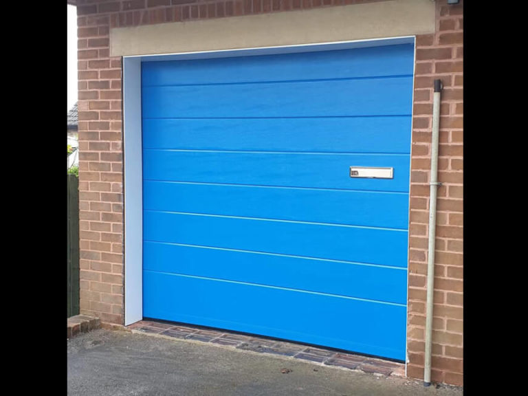 Sectional garage door with letter-box