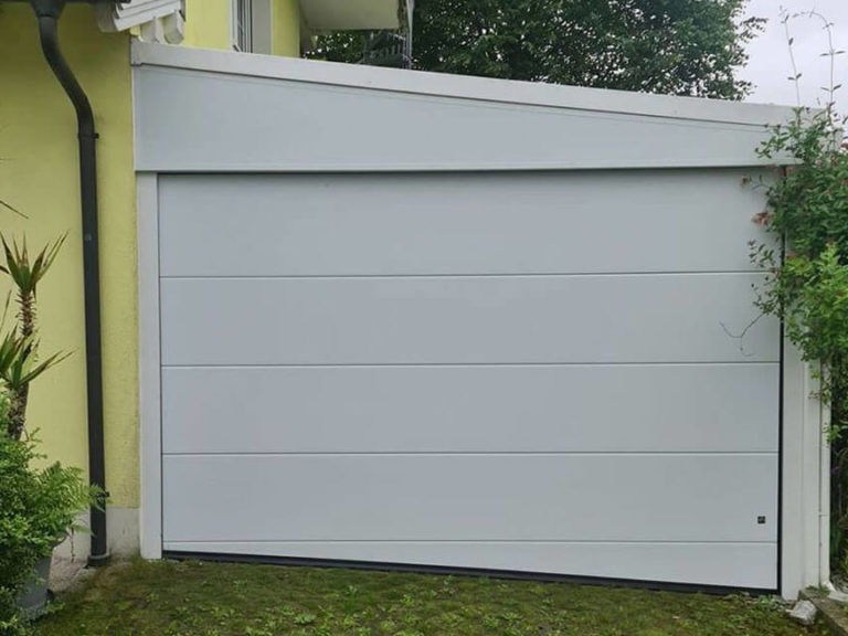 Glazed sectional garage door on the side-sloping driveway