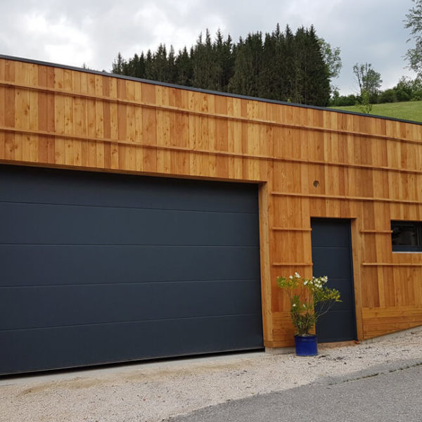 Sectional garage door on the side-sloping driveway