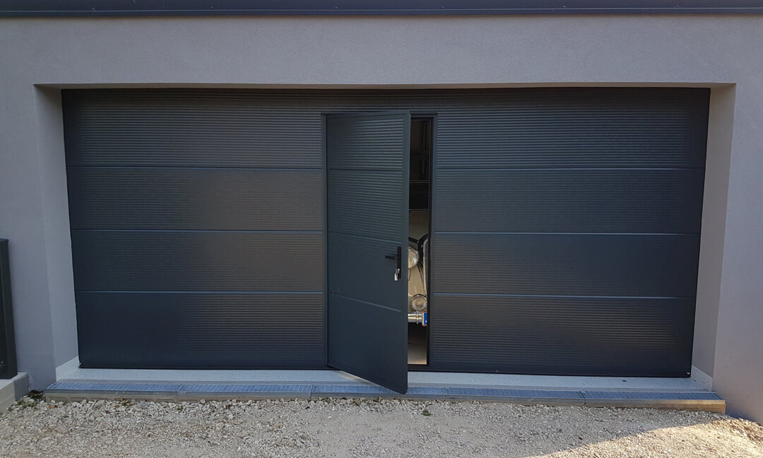 Sectional garage door with wicket