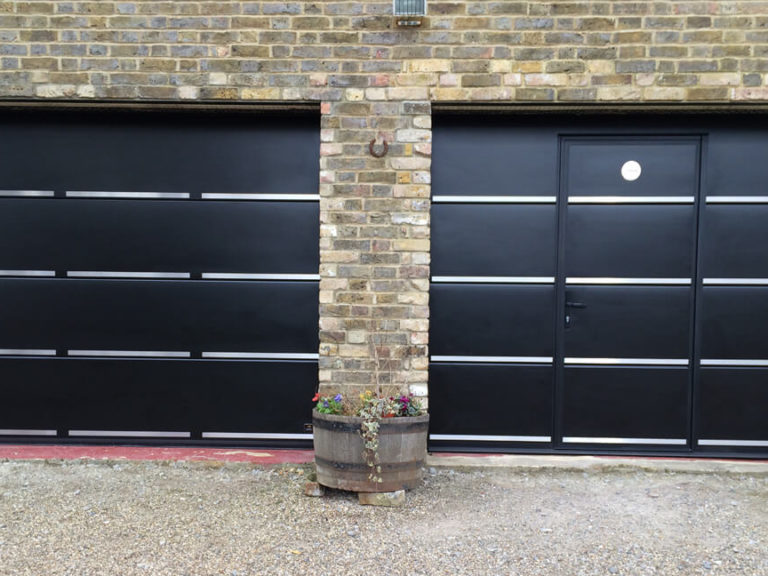 Garage doors with stainless metal decor accent