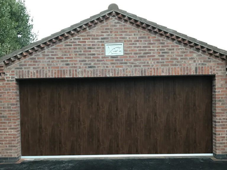 Masonry garage with 'Midrib-slick' door in 'Old Oak' finish