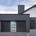 Garage door with oblong windows and applique