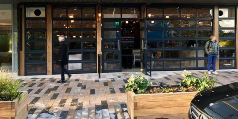 Façade formed out of of glazed sectional doors