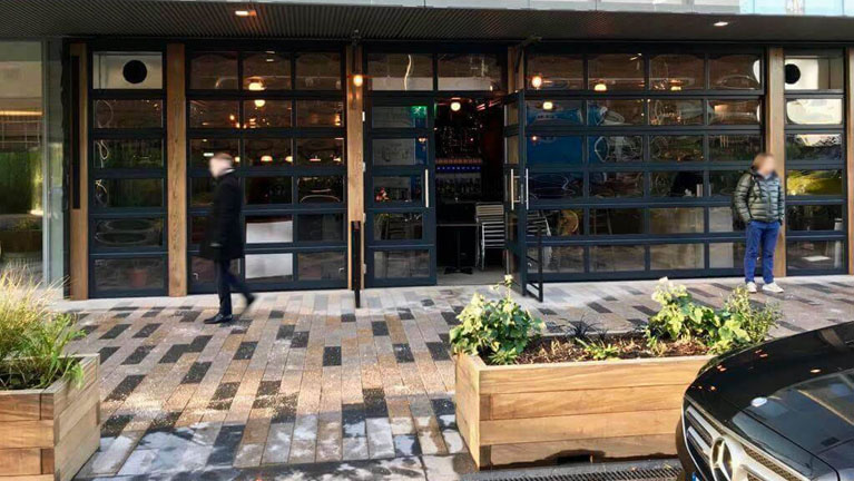 Vagabond (1) Façade formed out of of glazed sectional doors