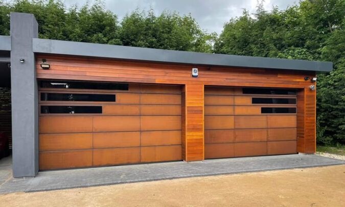 Twin garage doors clad with weathered corten Twin garage doors clad with weathered corten
