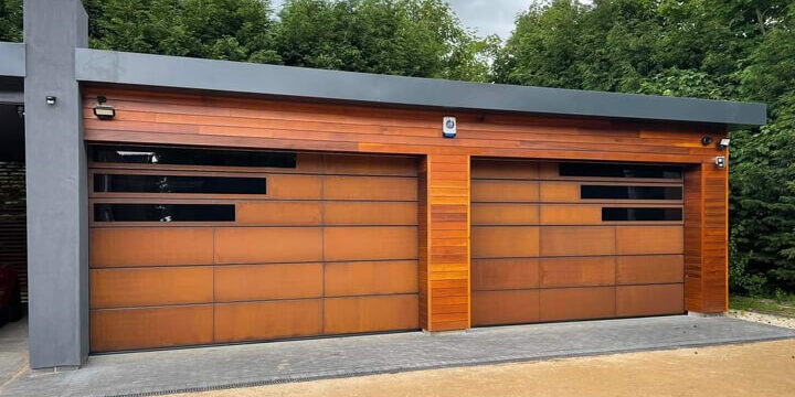 Twin garage doors clad with weathered corten