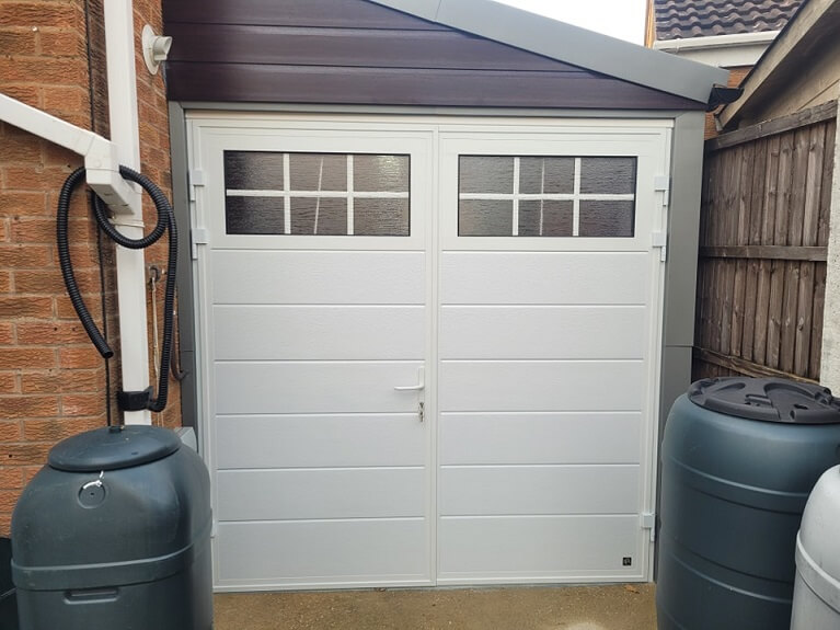 Garage conversion into hobby space with Traditional design garage door
