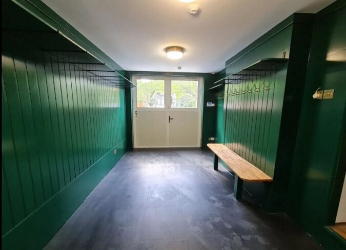 Garage conversion into dressing room with customised Traditional design garage door
